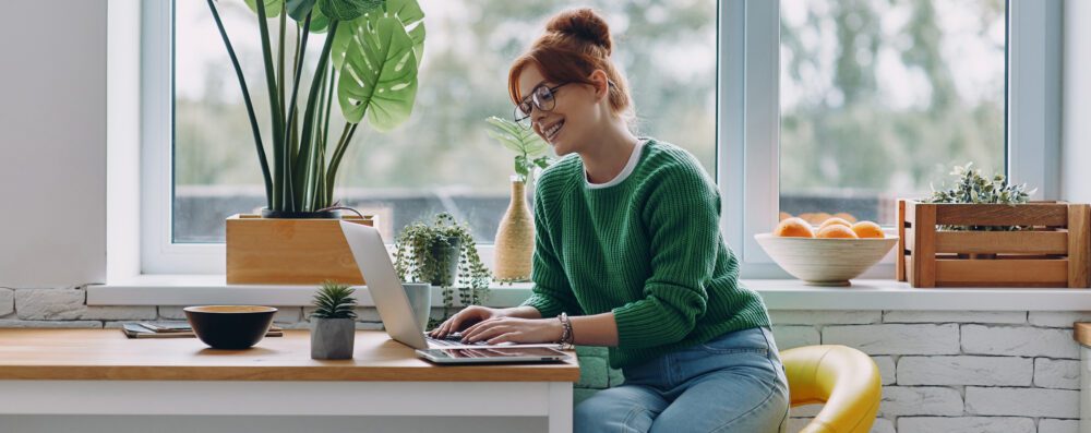 Woman at home browsing broadband.ie for cheap broadband plans
